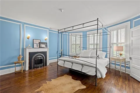 a bedroom with a bed and a fireplace