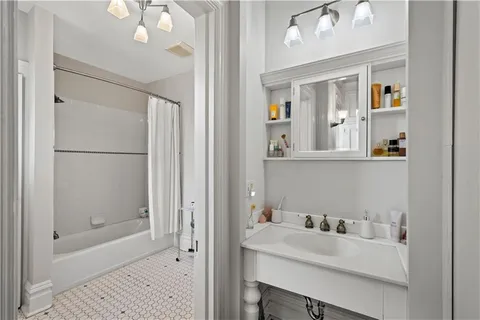 a bathroom with a sink vanity tub and shower