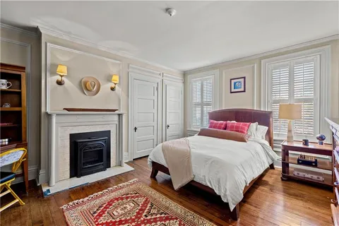a bedroom with a bed and a fireplace