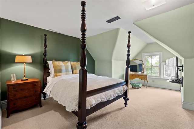 a bedroom with a bed couch and a window