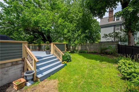 a view of yard with deck and garden