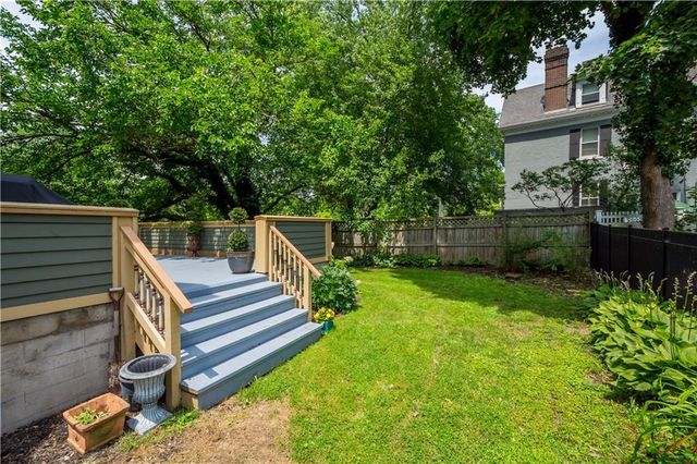 a view of yard with deck and garden