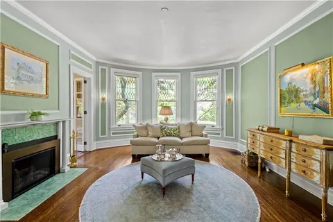 a living room with furniture large window and a fireplace