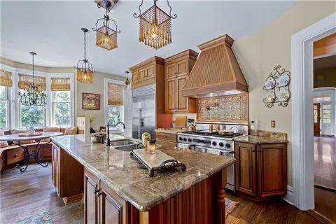 a kitchen with granite countertop a sink and a stove