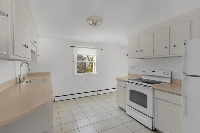 a kitchen with sink and cabinets