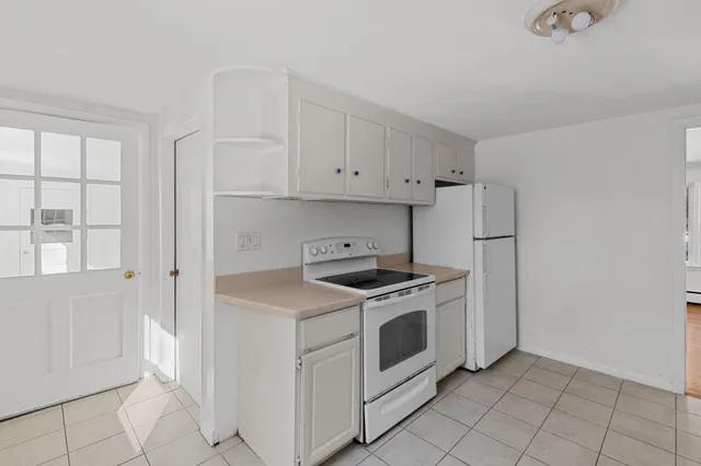 a view of a big room with a large window and front door