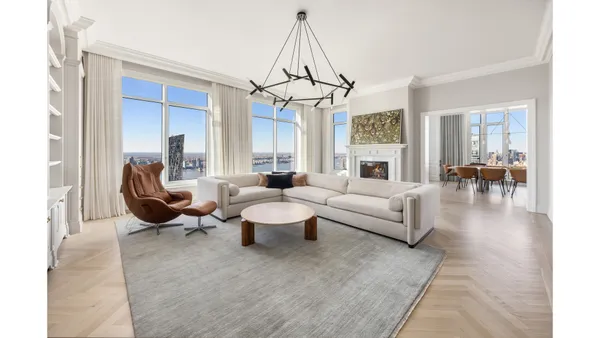 a living room with fireplace furniture and a chandelier