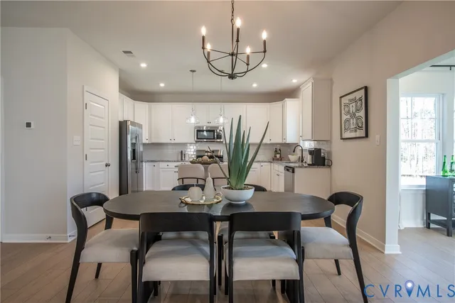 a view of a dining room with furniture and window