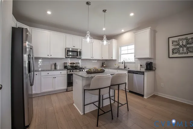 a kitchen with a sink cabinets and stainless steel appliances