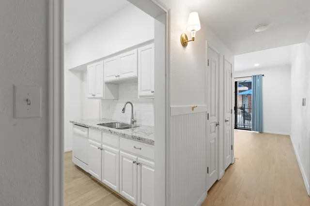 a bathroom with a granite countertop sink
