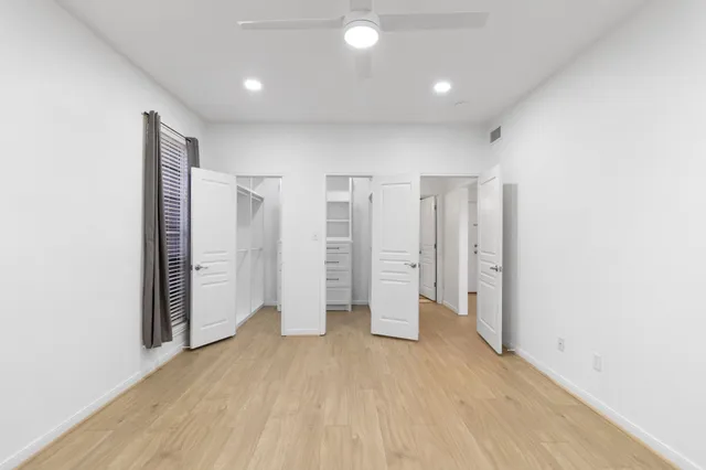 a view of empty room with wooden floor
