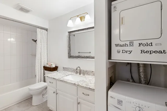 a bathroom with a granite countertop sink a toilet and a mirror