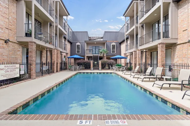 a view of a swimming pool with a outdoor seating