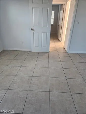 a view of a livingroom with an empty space and a refrigerator