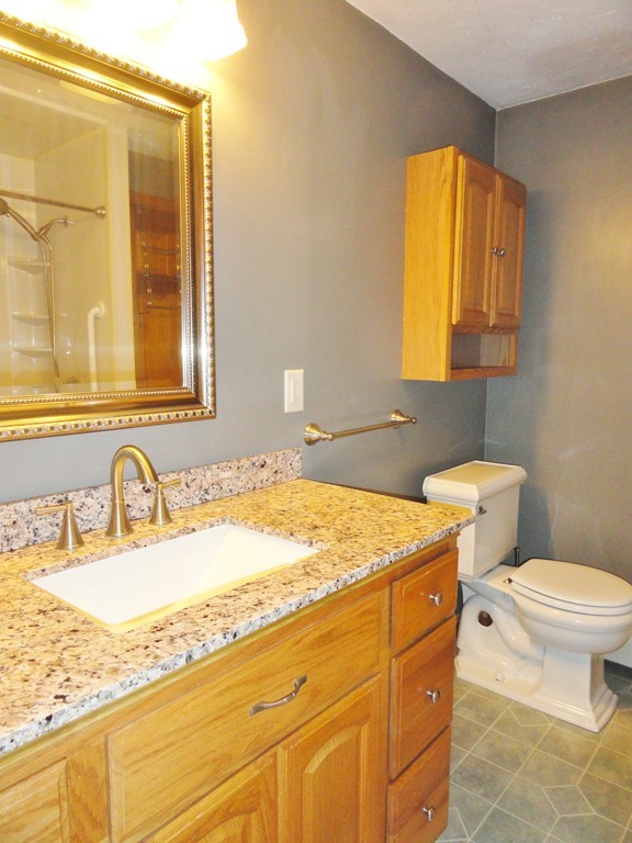 9 Edith Lane Rutland, MA 01543 - Photo 12 of 19 a bathroom with a granite countertop sink and a mirror