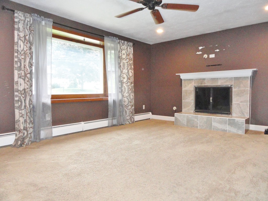 9 Edith Lane Rutland, MA 01543 - Photo 5 of 19 an empty room with chandelier fan and windows