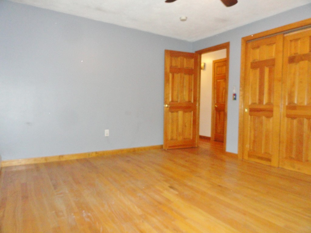 9 Edith Lane Rutland, MA 01543 - Photo 8 of 19 a view of an empty room with wooden floor and a window