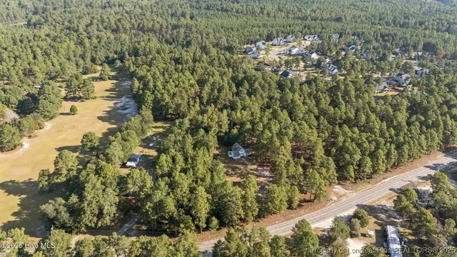 an aerial view of house with yard and mountain view in back