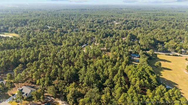 an aerial view of a house with a street