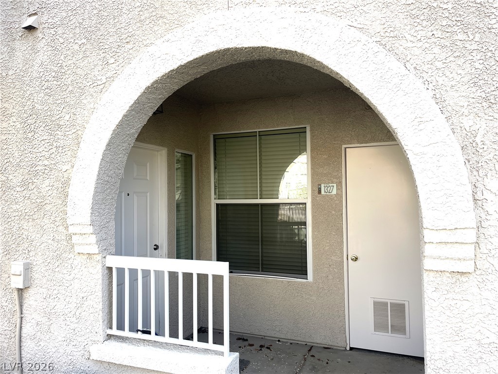 10001 Peace Way, Unit 1327 Las Vegas, NV 89147 - Photo 3 of 21 An inviting arched entryway welcomes you to a private, ground-level residence.