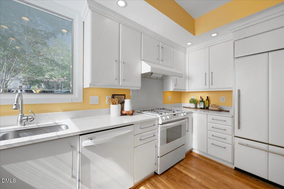 530 Elm Street Raleigh, NC 27604 - Photo 19 of 47 a kitchen with white cabinets and white appliances