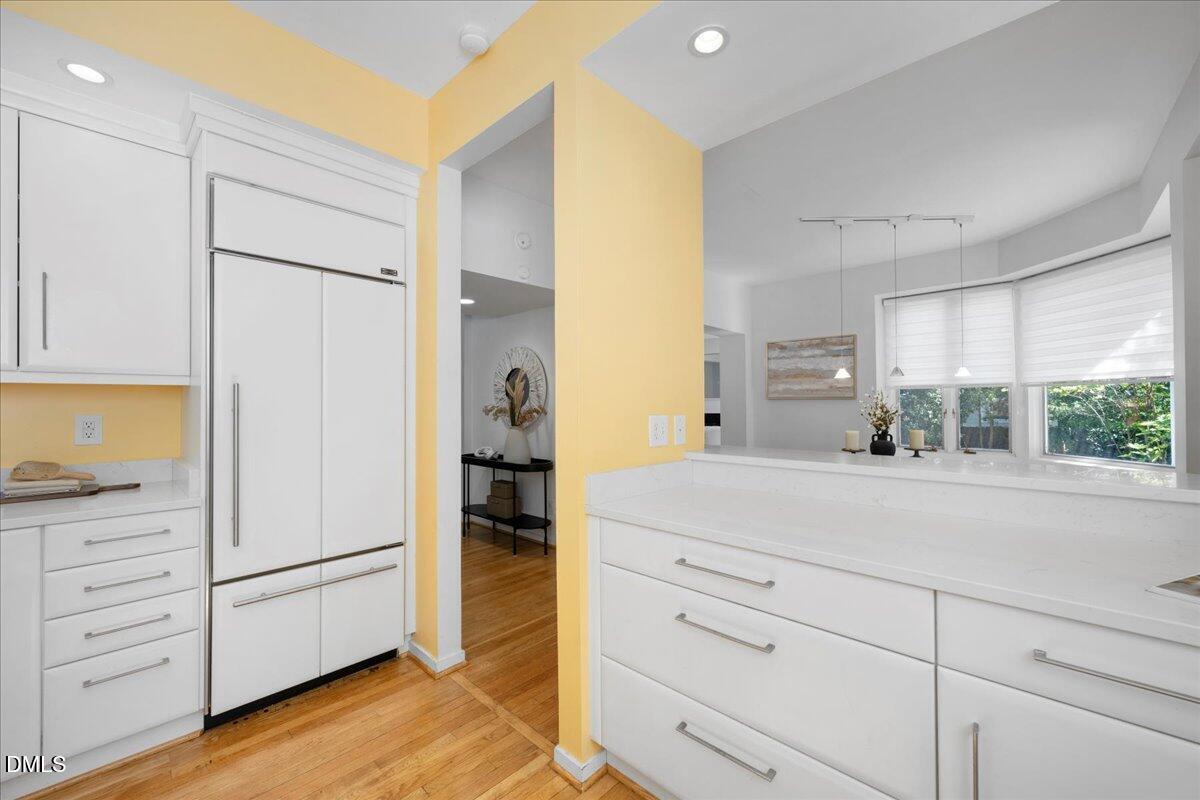 530 Elm Street Raleigh, NC 27604 - Photo 21 of 47 a kitchen with a refrigerator and cabinets
