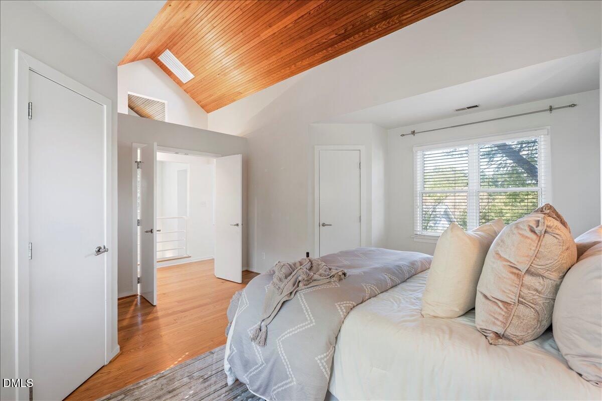 530 Elm Street Raleigh, NC 27604 - Photo 28 of 47 a bed sitting in a bedroom next to a window