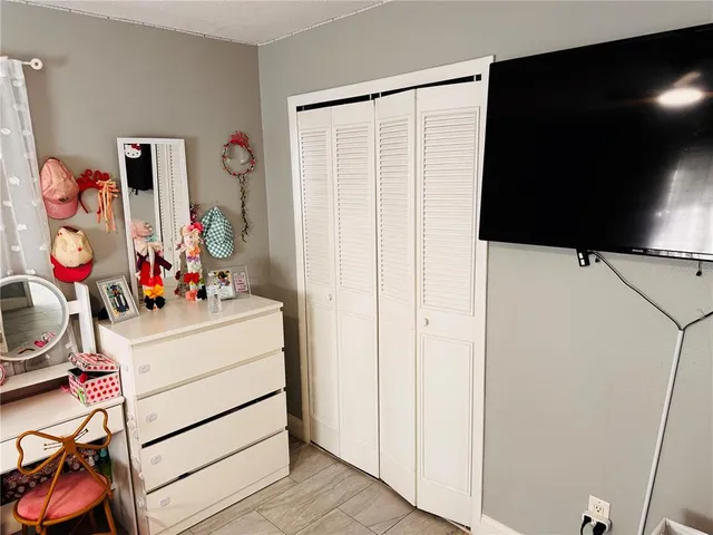 a bedroom with two bed and a window