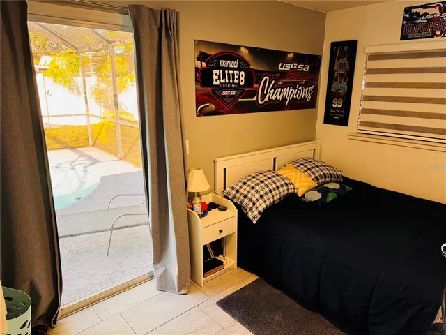 a living room with furniture and a dining table with kitchen view