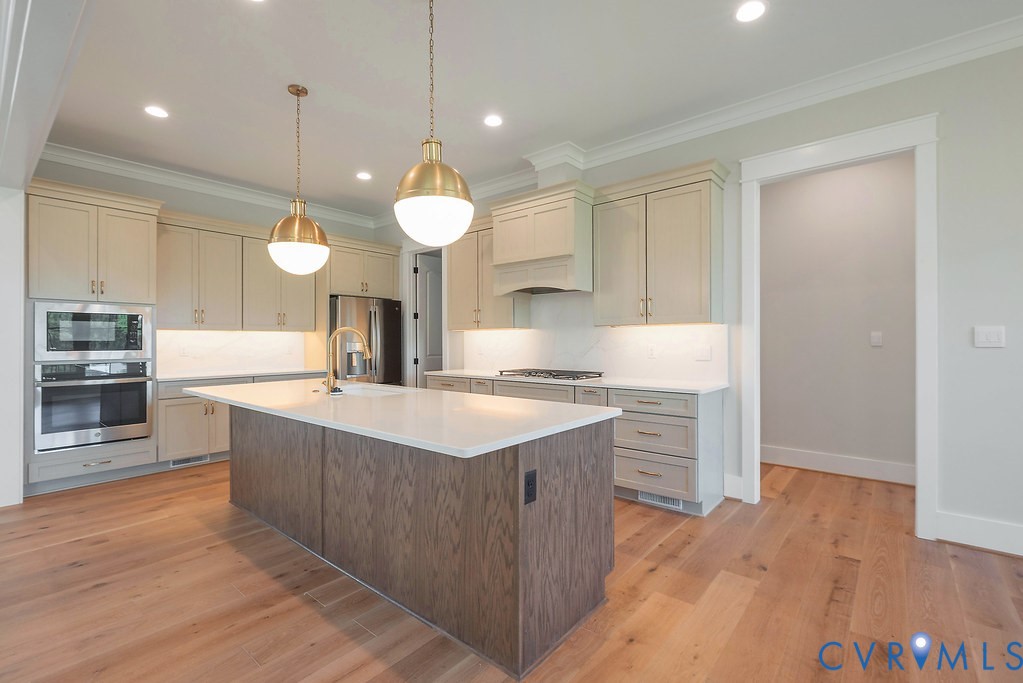 3530 Old Gun Road West Midlothian, VA 23113 - Photo 15 of 50 a large kitchen with a large counter top a sink stainless steel appliances and cabinets