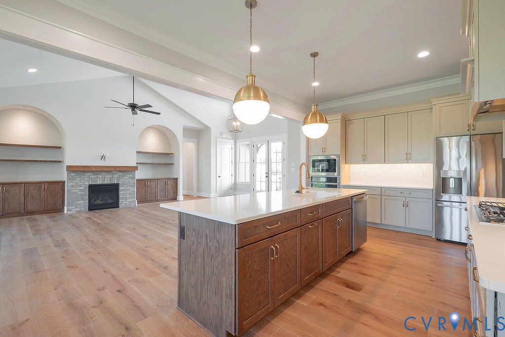 3530 Old Gun Road West Midlothian, VA 23113 - Photo 16 of 50 a large kitchen with a sink dishwasher a kitchen island a stove and a wooden floors