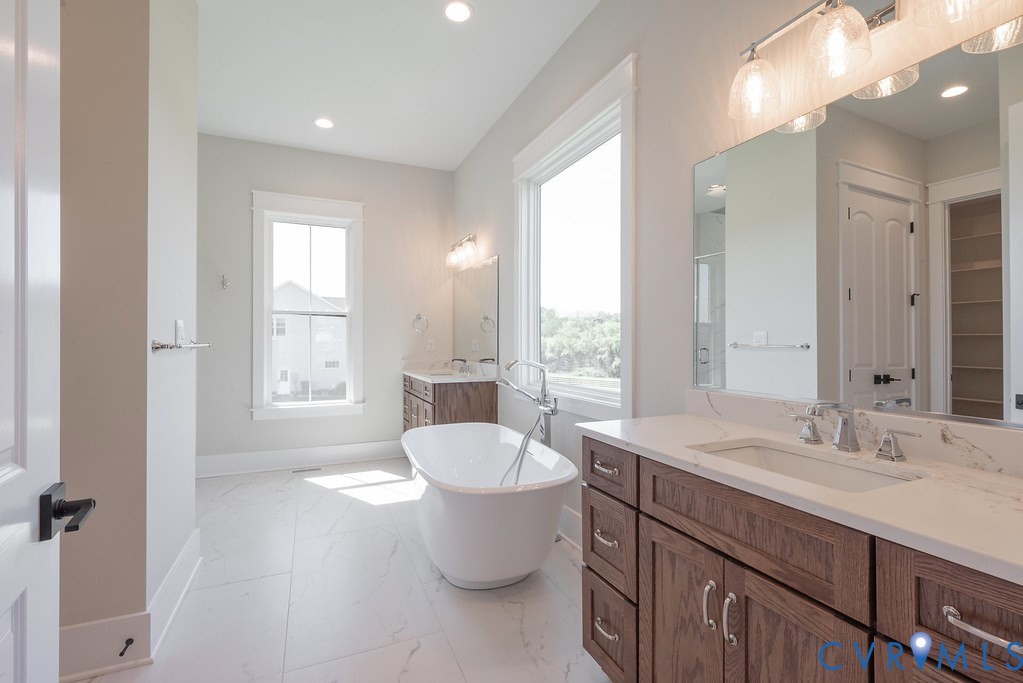 3530 Old Gun Road West Midlothian, VA 23113 - Photo 29 of 50 a large bathroom with a double vanity sink toilet and a mirror
