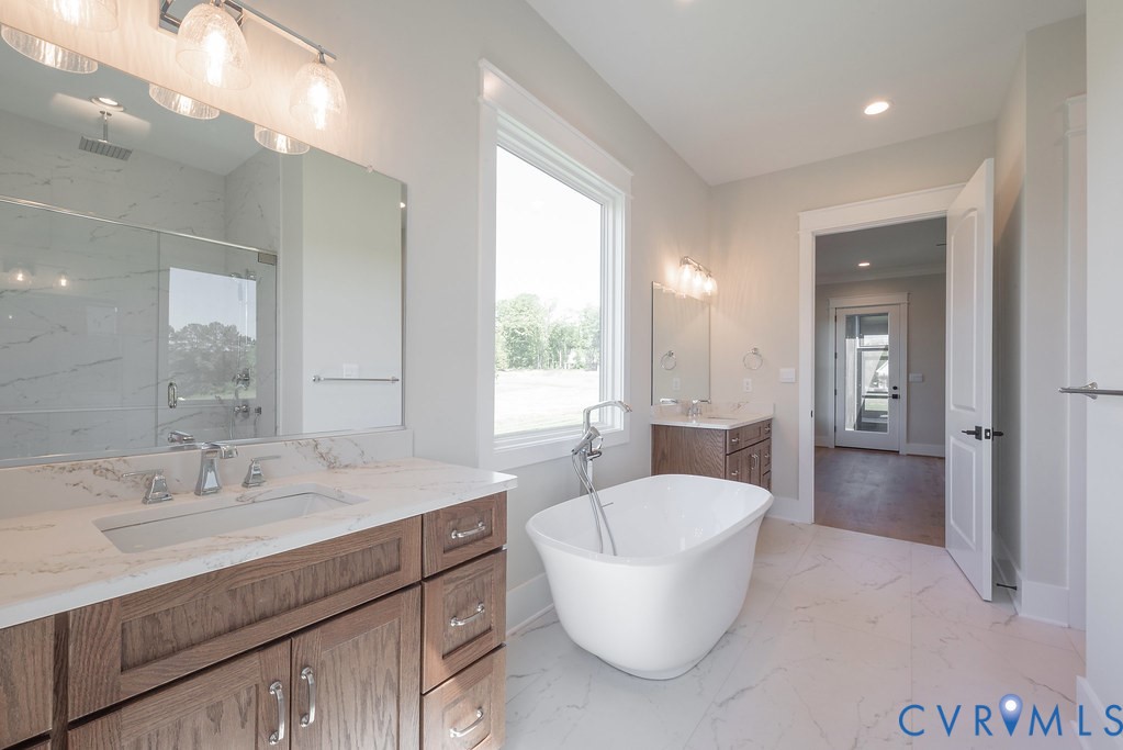 3530 Old Gun Road West Midlothian, VA 23113 - Photo 32 of 50 a spacious bathroom with a bathtub sink and mirror