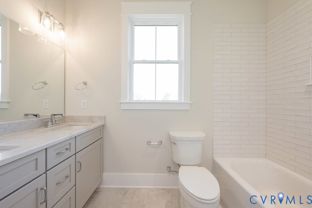 3530 Old Gun Road West Midlothian, VA 23113 - Photo 37 of 50 a bathroom with a granite countertop toilet a sink and bathtub