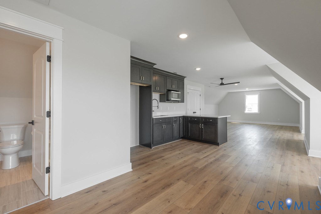 3530 Old Gun Road West Midlothian, VA 23113 - Photo 41 of 50 a kitchen with stainless steel appliances a refrigerator and a wooden floor