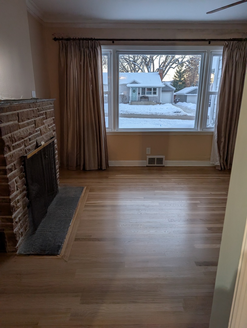 3618 Maple Avenue McHenry, IL 60050 - Photo 4 of 15 wooden floor in an empty room with a fireplace