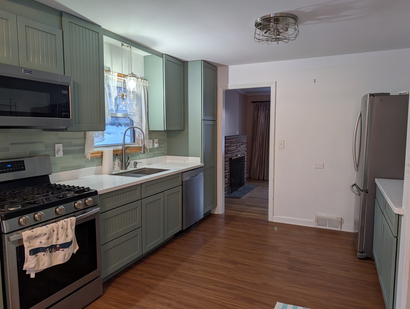 3618 Maple Avenue McHenry, IL 60050 - Photo 8 of 15 a kitchen with stainless steel appliances a refrigerator stove and sink