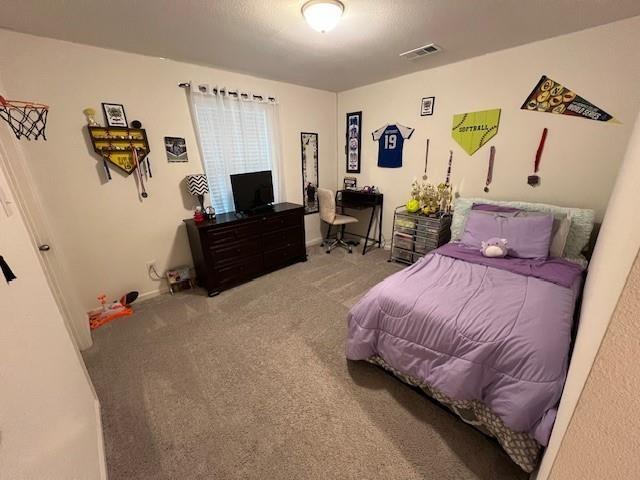 1908 Marquette Road Princeton, TX 75407 - Photo 9 of 14 Bright interior room featuring a single window with blinds and sheer curtains, light neutral carpeting, and a flush mount ceiling light