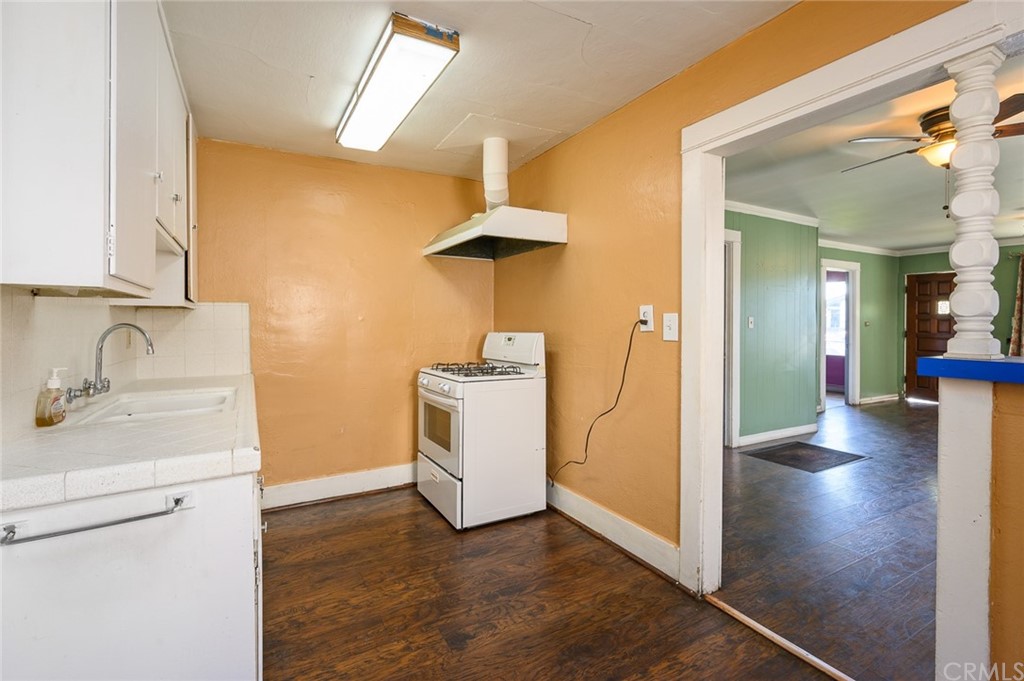 355 West Spruce Street Compton, CA 90220 - Photo 11 of 27 a view of a kitchen with a sink and dishwasher with wooden floor