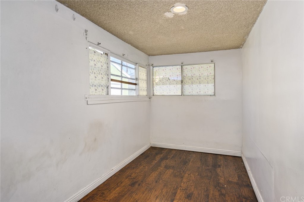 355 West Spruce Street Compton, CA 90220 - Photo 12 of 27 an empty room with wooden floor and windows