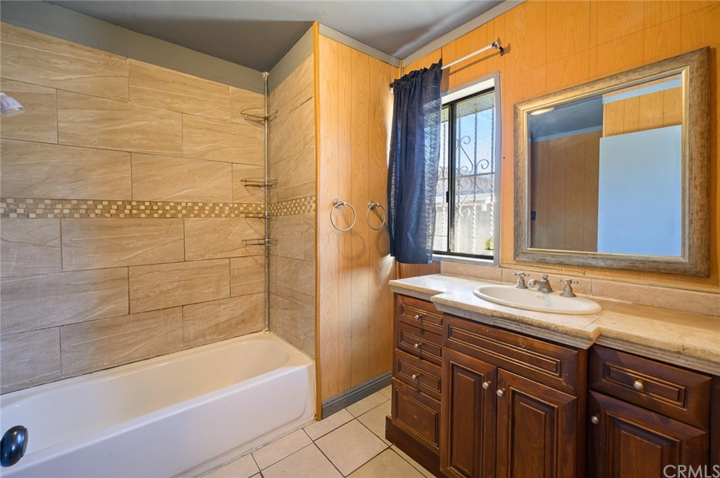 355 West Spruce Street Compton, CA 90220 - Photo 19 of 27 a bathroom with a granite countertop sink mirror bathtub and shower