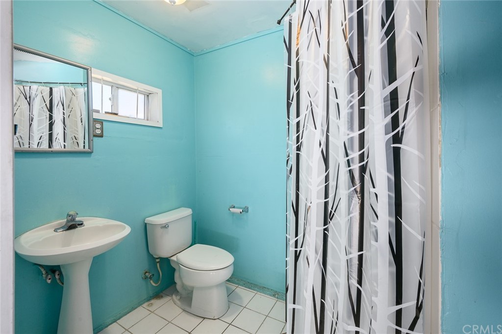 355 West Spruce Street Compton, CA 90220 - Photo 22 of 27 a bathroom with a toilet sink and mirror