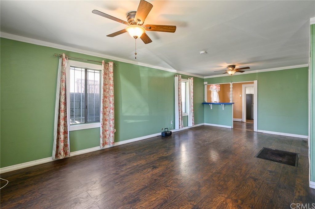355 West Spruce Street Compton, CA 90220 - Photo 5 of 27 a view of an empty room with a window and wooden floor