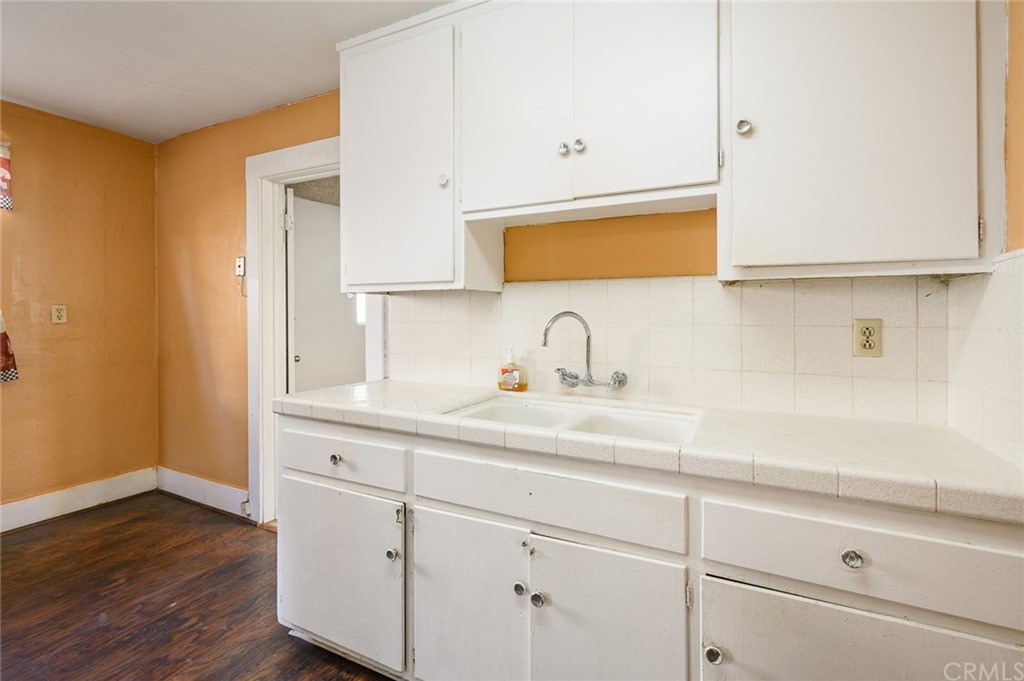 355 West Spruce Street Compton, CA 90220 - Photo 9 of 27 a kitchen with a sink and wooden floor