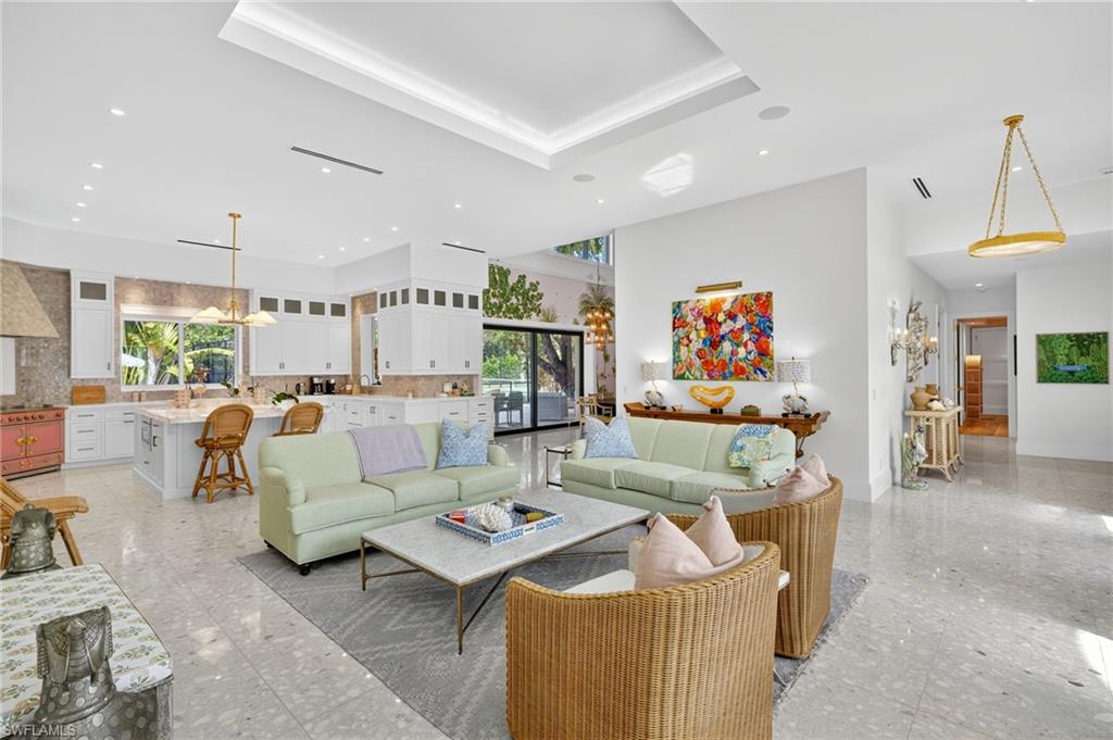 111 Caribbean Road Naples, FL 34108 - Photo 13 of 50 a living room with furniture and a table