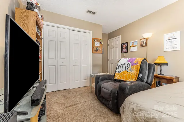 a bedroom with two beds and painting on the wall
