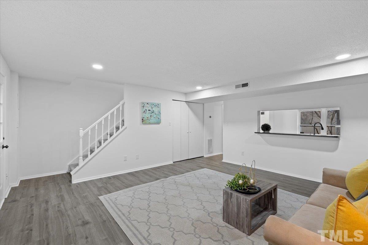 7721 Sandra Lane Raleigh, NC 27615 - Photo 14 of 29 a view of entryway and hall with wooden floor