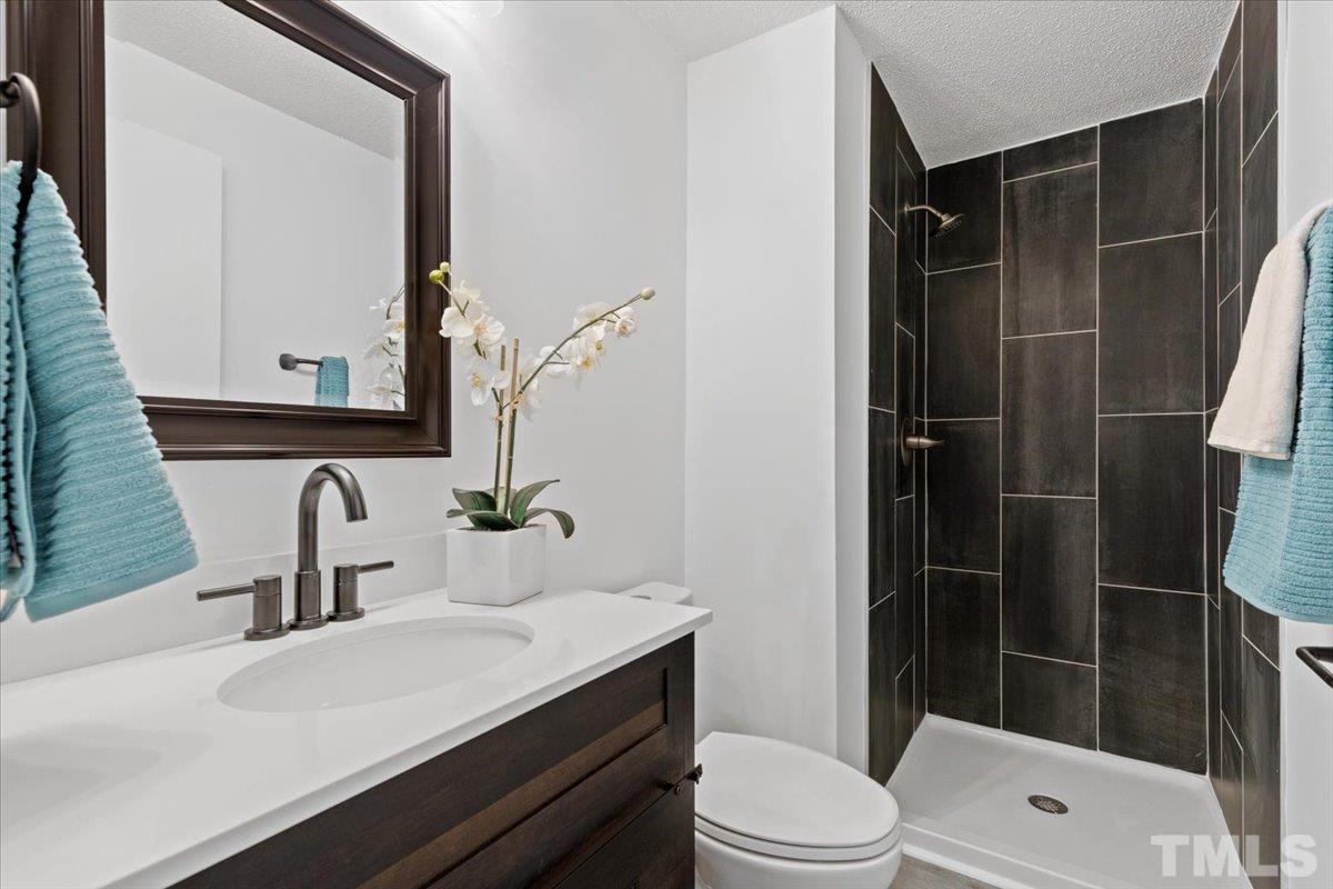 7721 Sandra Lane Raleigh, NC 27615 - Photo 20 of 29 a bathroom with a sink toilet and shower