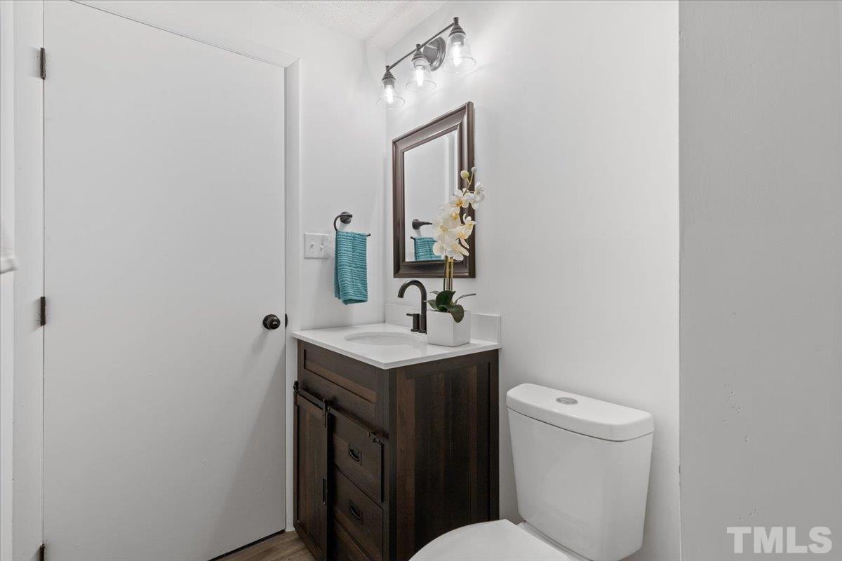7721 Sandra Lane Raleigh, NC 27615 - Photo 21 of 29 a bathroom with a toilet sink and mirror