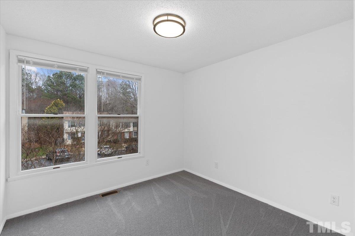 7721 Sandra Lane Raleigh, NC 27615 - Photo 25 of 29 an empty room with a window